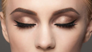 Closeup image of woman closed eyes with beautiful bright makeup. Makeup with eyeliner and falce eyelashes