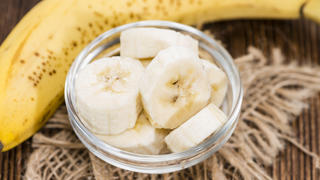 Banana Pieces in a bowl (close-up shot) with some fresh fruits