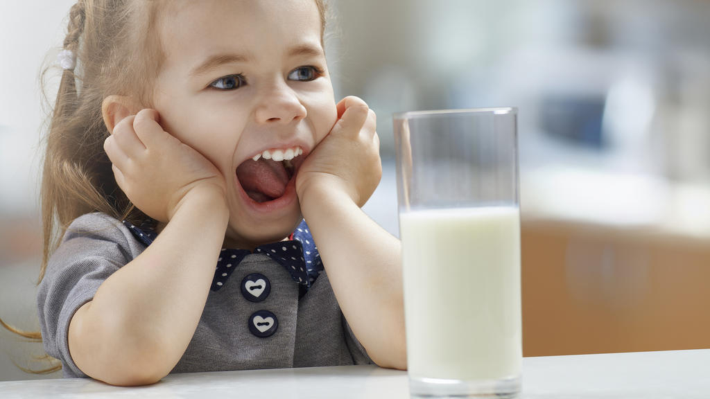 girl drinking milk at the kitchen
