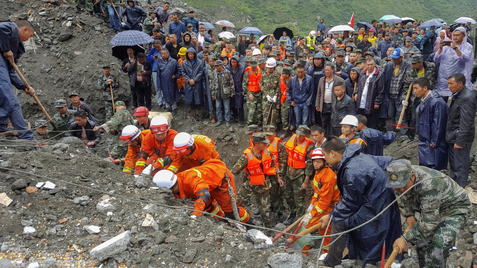 People search for survivors at the site of a landslide in Xinmo Village, Mao County, Sichuan province, China June 24, 2017. China Daily via REUTERS ATTENTION EDITORS - THIS IMAGE WAS PROVIDED BY A THIRD PARTY. CHINA OUT. NO COMMERCIAL OR EDITORIAL SA