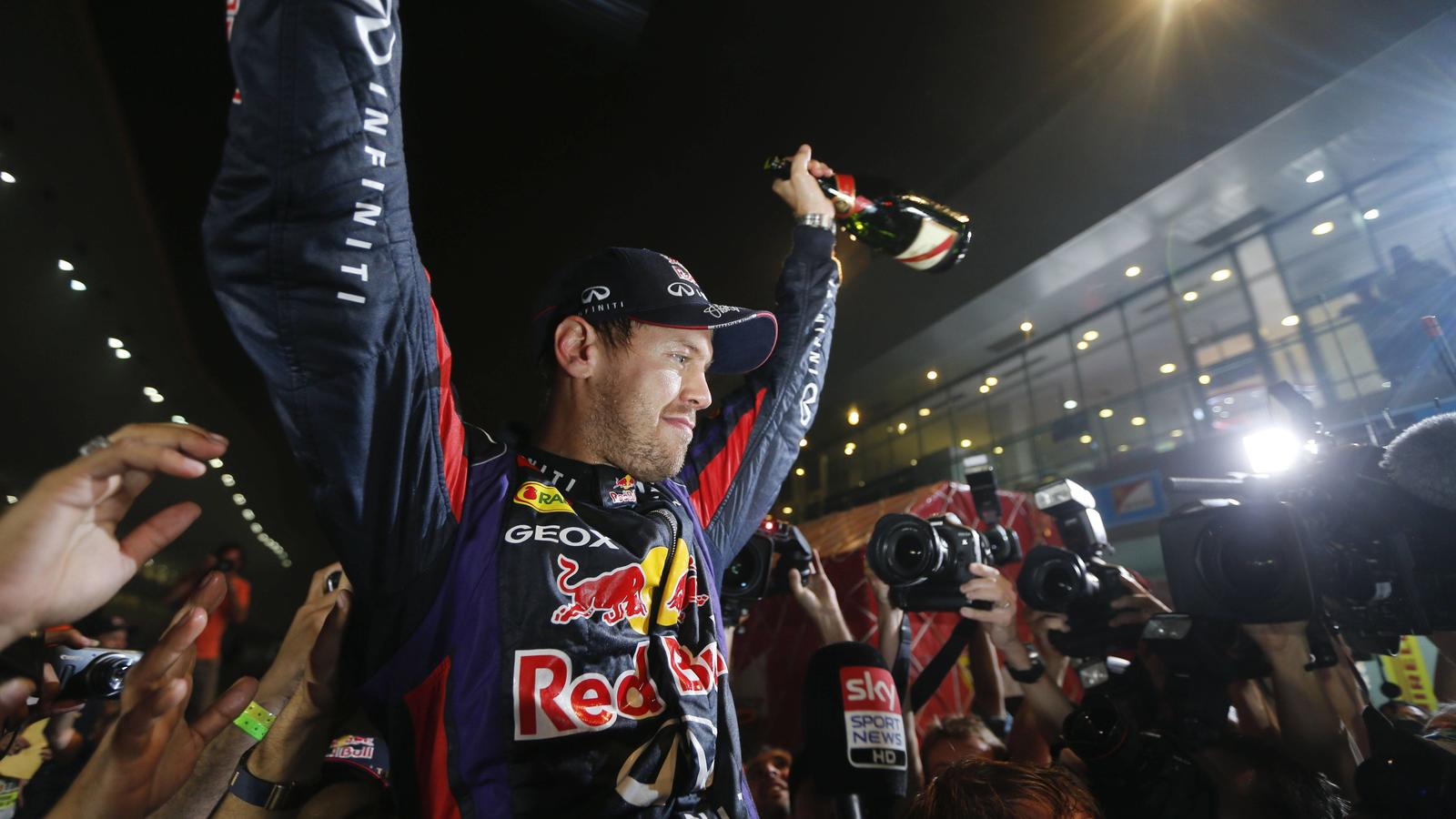 Oct. 27, 2013 - New Delhi, India - SEBASTIAN VETTEL of Germany and Infiniti Red Bull Racing is seen celebrating in the pit lane after claiming his fourth consecutive Formula 1 World Championship at the Formula 1 Indian Grand Prix 2013 at the Buddh In