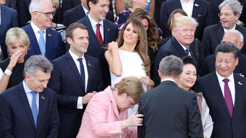 (2nd row L-R) Wife of French President Brigitte Trogneux, French President Emmanuel Macron, US First Lady Melania Trump, US President Donald Trump as German Chancellor Angela Merkel is seen in front during a family photo prior to a concert at the Elb
