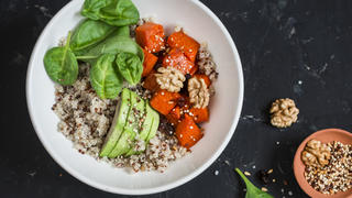 Quinoa and pumpkin bowl. Vegetarian, healthy, diet food. On a dark background, top view