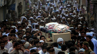 Men carry the coffin of a policeman who was killed in a suicide blast a day earlier, during his funeral in Lahore, Pakistan July 25, 2017. REUTERS/Mohsin Raza