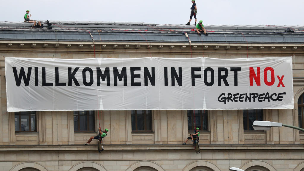 Activists of Greenpeace attach a banner that reads "Welcome to Fort NOx" to Germany's Federal Ministry of Transport and Digital Infrastructure before ministers and car executives will meet on Wednesday to agree ways to cut inner-city pollution to try