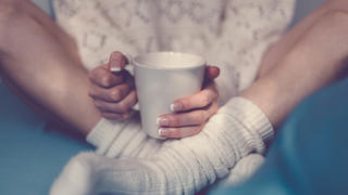 Girl with coffee cup in bed