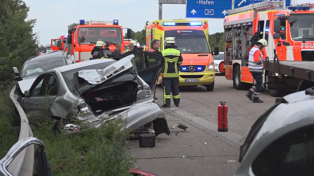 Ein Autowrack und mehrere Einsatzwagen der Rettungskräfte stehen am 16.08.2017 auf der Auobahn 29 bei Oldenburg (Niedersachsen). Bei dem Unfall wurden sieben Menschen verletzt, vier von ihnen schwer. Mehrere Autofahrer hatten in der Rettungsgasse gew