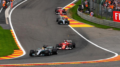 SPA, BELGIUM - AUGUST 27:  Lewis Hamilton of Great Britain driving the (44) Mercedes AMG Petronas F1 Team Mercedes F1 WO8 leads Sebastian Vettel of Germany driving the (5) Scuderia Ferrari SF70H and the rest of the field up Eau Rouge during the Formu