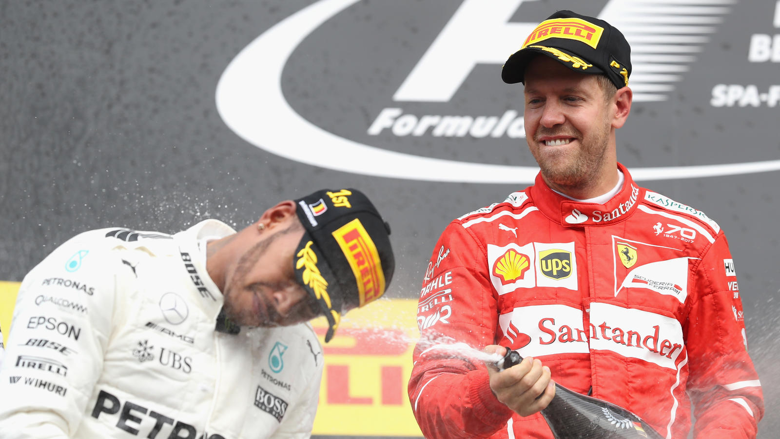 SPA, BELGIUM - AUGUST 27: Race winner Lewis Hamilton of Great Britain and Mercedes GP and second place Sebastian Vettel of Germany and Ferrari celebrate on the podium during the Formula One Grand Prix of Belgium at Circuit de Spa-Francorchamps on Aug