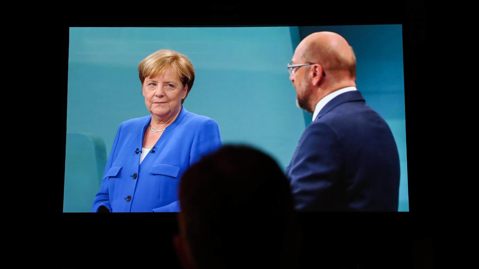 TV Duell zur Bundestagswahl - Liveübertragung  (170904) -- BERLIN, Sept. 4, 2017 -- A man watches the TV duel between German Chancellor Angela Merkel and Martin Schulz, chancellor candidate of the Social Democratic Party (SPD), at a media center in B