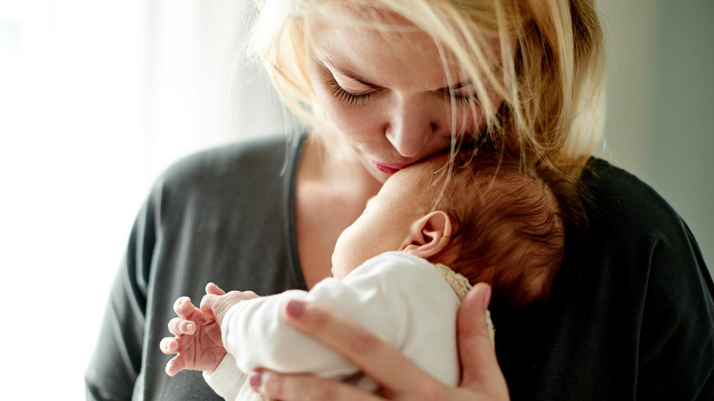 Shot of a mother spending time with her newborn baby