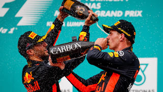 KUALA LUMPUR, MALAYSIA - OCTOBER 01:  Race winner Max Verstappen of Netherlands and Red Bull Racing celebrates with third place finisher Daniel Ricciardo of Australia and Red Bull Racing on the podium during the Malaysia Formula One Grand Prix at Sepang Circuit on October 1, 2017 in Kuala Lumpur, Malaysia.  (Photo by Lars Baron/Getty Images) *** BESTPIX ***