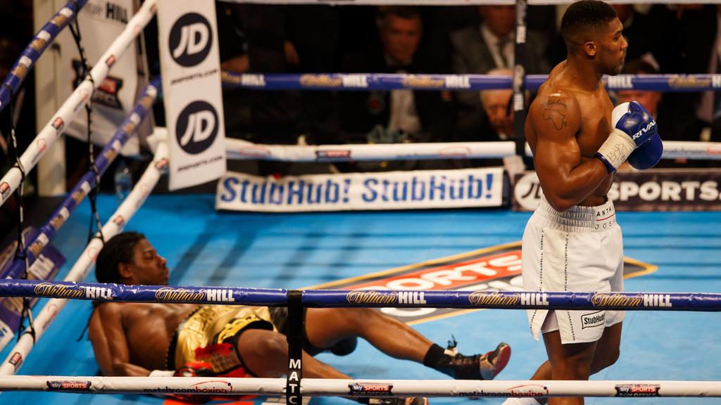 ANTHONY JOSHUA knocks CHARLES MARTIN to the floor during the IBF World Heavyweight title at the O2 Arena, London on April 9th 2016 / Boxing - Martin v Joshua - 9/4/2016 Boxing - IBF Heavyweight Championship - Charles Martin v Anthony Joshua O2 Arena,