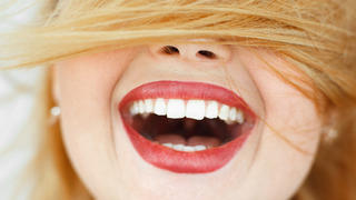 Happy laughing woman with red hair close-up. portrait of unrecognizable carroty girl with wide perfect smile. Fun, gladness, joy concept