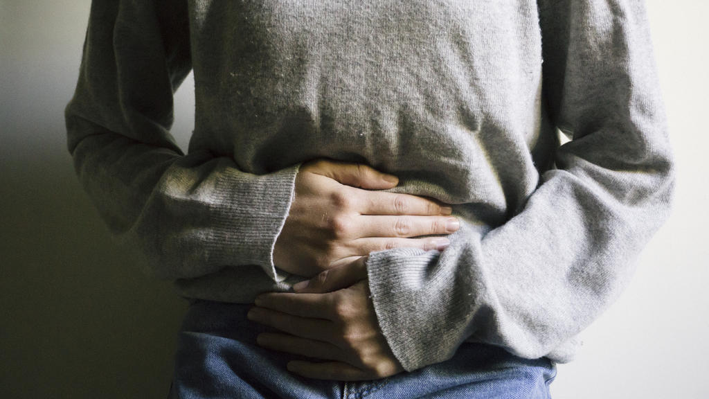 Woman suffering from stomach ache