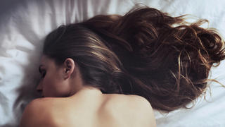 Cropped shot of a beautiful young woman sleeping on her bed