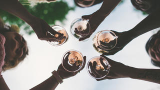 Woman toasting with sparkling wine and champagne