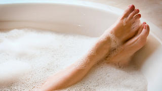 Woman in bathtub. Bubble Bath. Horizontal shot.