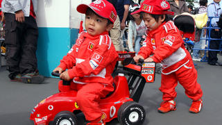 Two young Japanese kids wearing Ferrari overalls play before the Japanese Grand Prix at the racetrack in Suzuka, Japan, Sunday 08 October 2006. Photo: Franck Robichon +++(c) dpa - Report+++