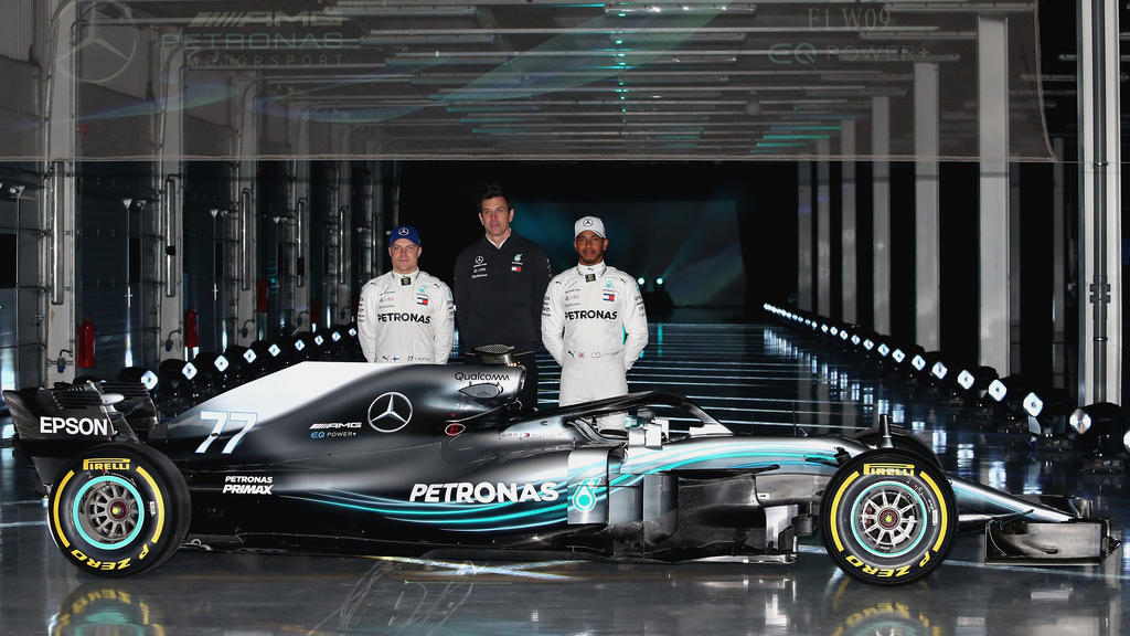 NORTHAMPTON, ENGLAND - FEBRUARY 22: (l-r) Valtteri Bottas of Finland and Mercedes GP, Mercedes GP Executive Director Toto Wolff and Lewis Hamilton of Great Britain and Mercedes GP pose for a photo with the Mercedes W09 during the launch of the Merce