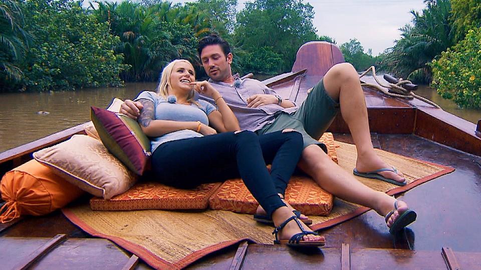 In einem landestypischen Boot geht es für Carina und Daniel über den Mekong-Fluss.