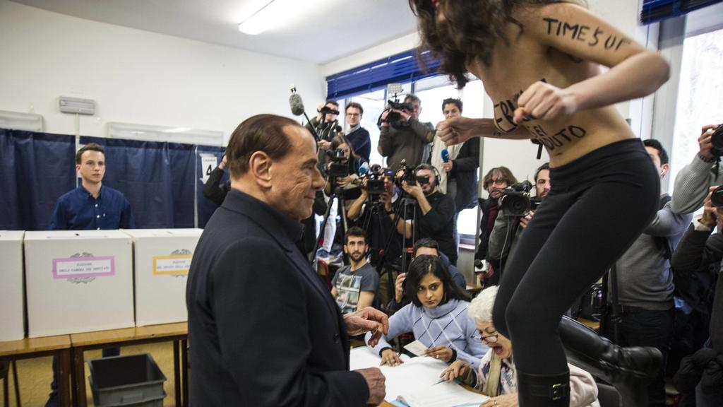 Political and Regional elections 2018, Femen woman activist Protest against Silvio Berlusconi during the vote, showing naked breasts with the words "Berlusconi Sei Scaduto"