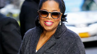 Oprah Winfrey waves hello when she arrives at Colbert show in New York