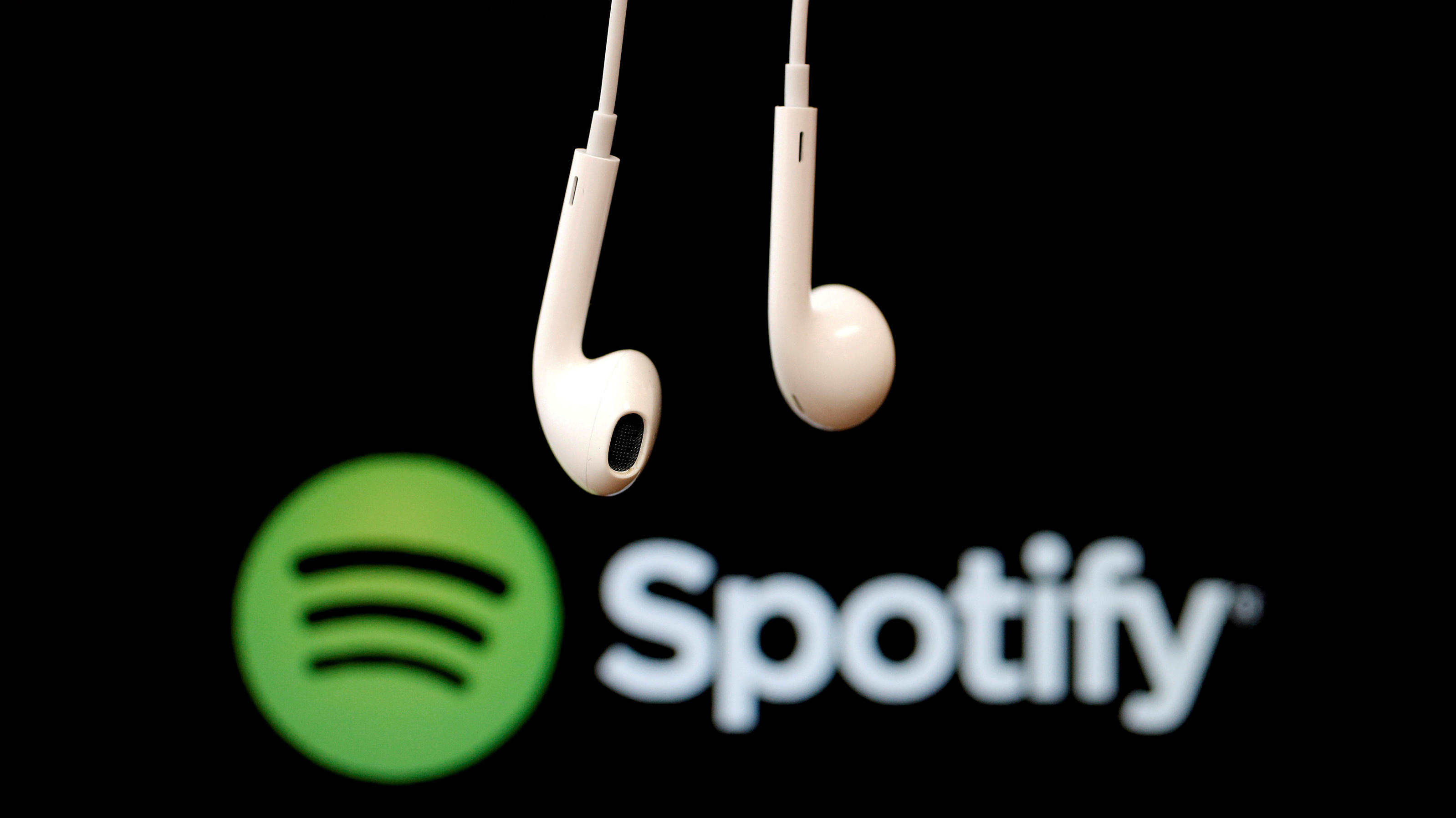 FILE PHOTO: Headphones are seen in front of a logo of online music streaming service Spotify,  February 18, 2014 REUTERS/Christian Hartmann/File Photo