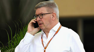 BAHRAIN, BAHRAIN - APRIL 05: Ross Brawn, Managing Director (Sporting) of the Formula One Group, talks on the phone in the Paddock during previews ahead of the Bahrain Formula One Grand Prix at Bahrain International Circuit on April 5, 2018 in Bahrain, Bahrain.  (Photo by Clive Mason/Getty Images)