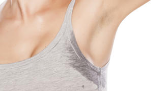 attractive girl is disgusted by her sweaty armpits