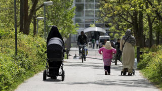 In this May 28, 2010 file photo, Muslim women walk in a park in Aarhus, Denmark. Denmark should halt immigration from Muslim countries, an anti-immigration and nationalist group that supports the center-right government said, citing the threat of vi