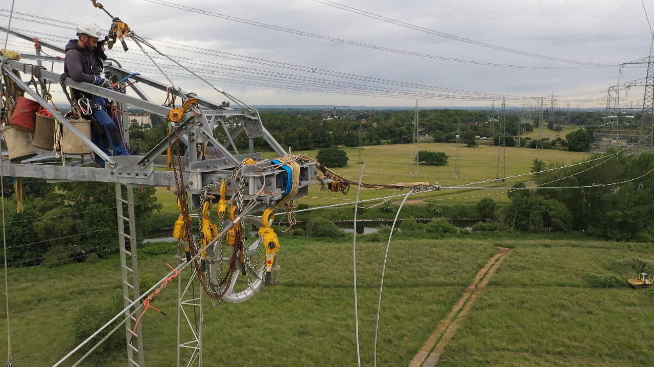 Monteure ziehen neue Stromleitungen In 55 Metern Höhe