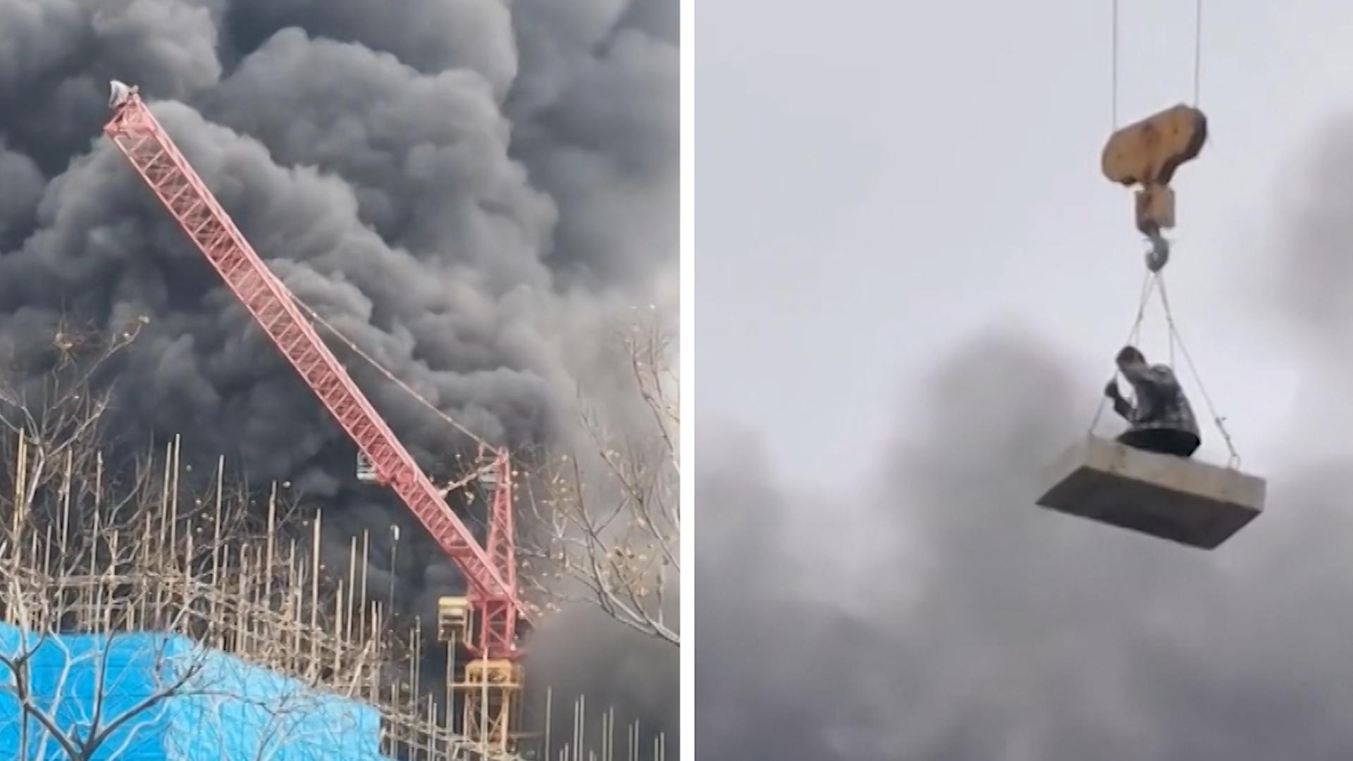 Auf Ausleger gefangen: Kranfahrer rettet Arbeiter mit Platte Baustelle nach Brand in Rauch gehüllt